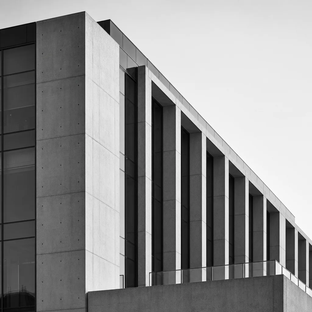 Minimalist architectural visual narrative capturing sharp shadows and brutalist lines